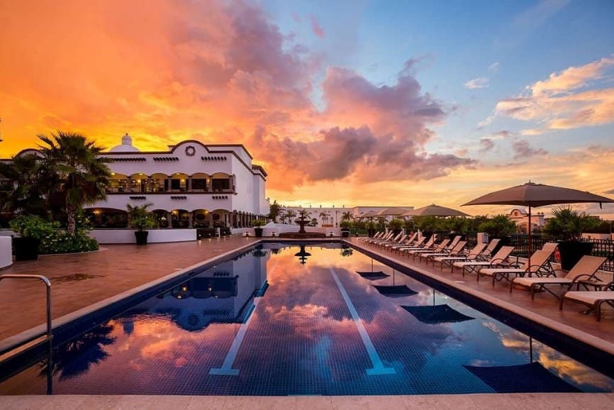 Sunset by the swimming pool at Grand Residences Riviera Cancun