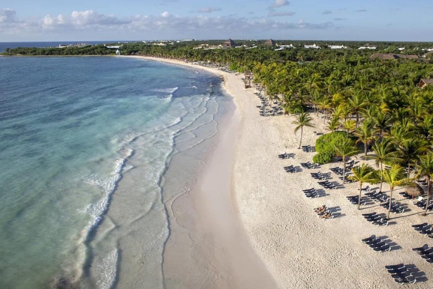 Beach with palapas at Grand Palladium Kantenah Resort & Spa in Akumal