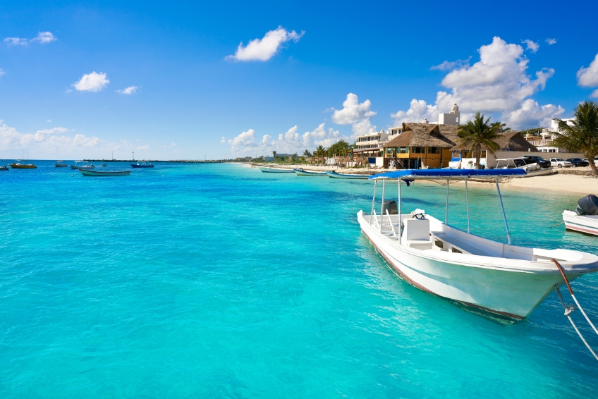 Boat on turquoise water of the Riviera Maya in Mexico