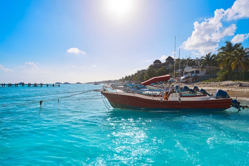 Boat on turquoise water in Playa del Carmen
