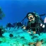 Scuba diver exploring vibrant coral reef in Cozumel, Mexico with tropical fish